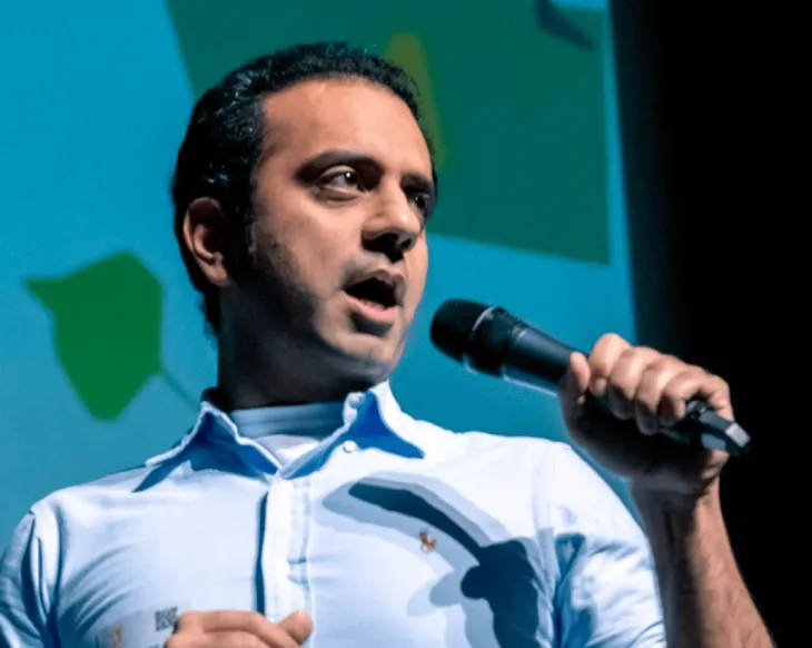 A man standing in front of a microphone.